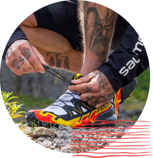 Man tying Salomon Speedcross up close